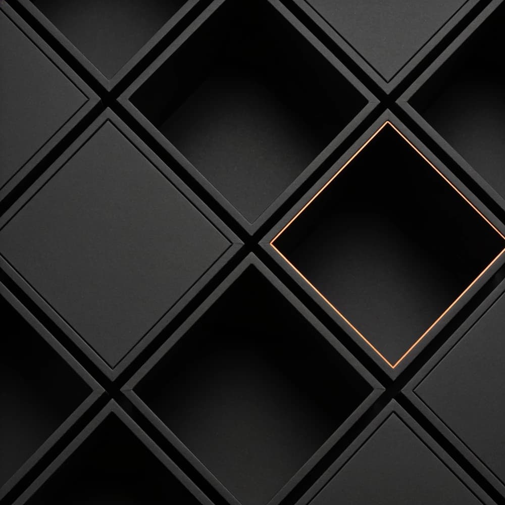 Diagonal grid of dark recessed compartments with one compartment outlined in orange